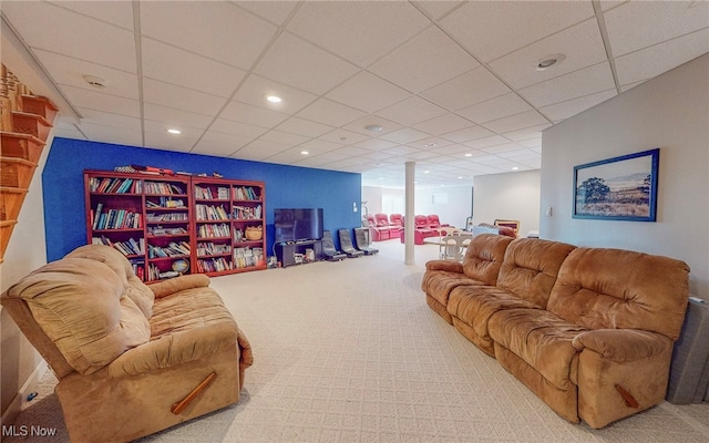 living room with carpet floors and a paneled ceiling