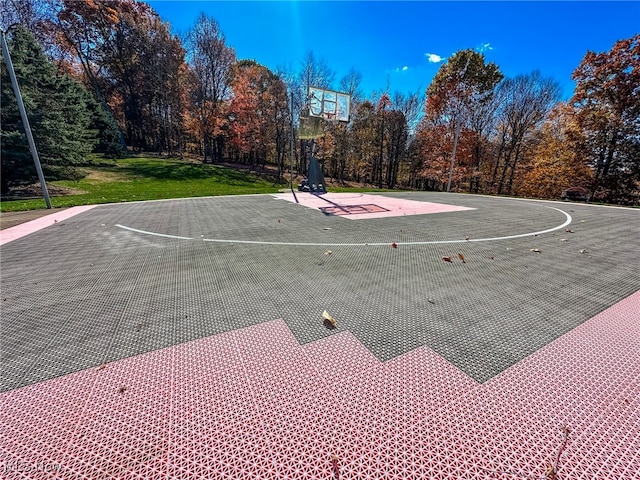 view of sport court featuring a yard