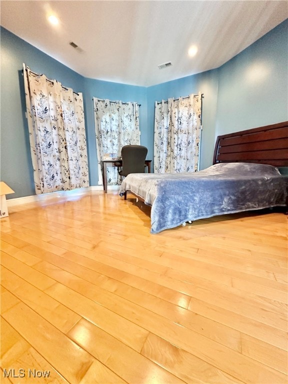 unfurnished bedroom with hardwood / wood-style flooring