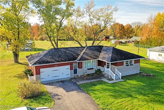 ranch-style home with a porch, a front lawn, and a garage