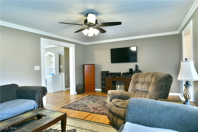 living room with ceiling fan, crown molding, and light wood-type flooring