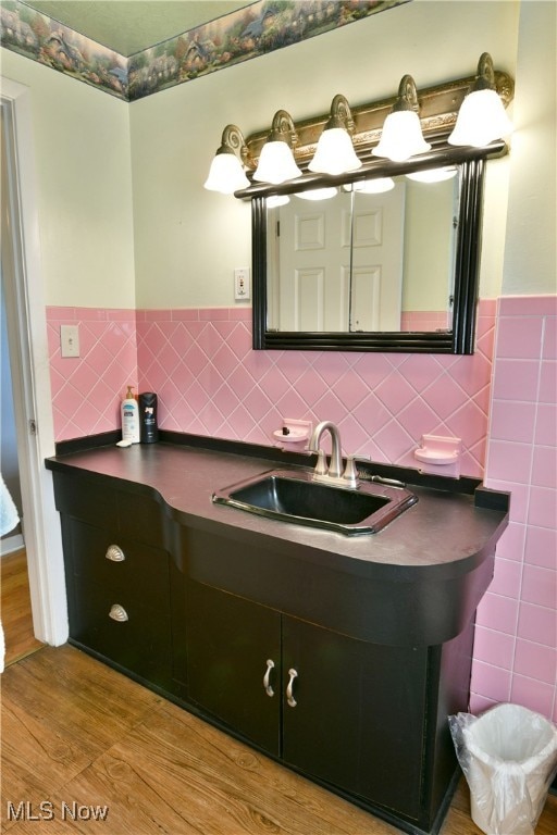 bathroom featuring tile walls, vanity, and hardwood / wood-style floors