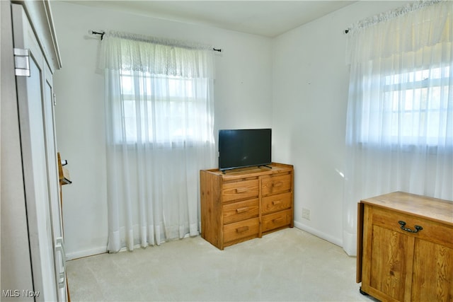 bedroom featuring light carpet