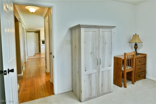 hall featuring ornamental molding and light wood-type flooring