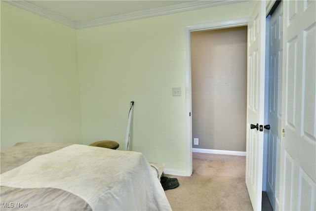 bedroom featuring ornamental molding and light colored carpet