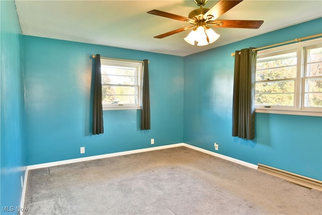 spare room featuring carpet floors and ceiling fan