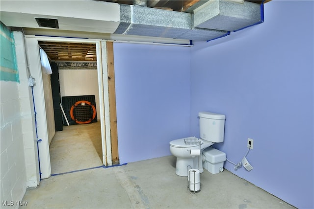 bathroom featuring toilet and concrete floors