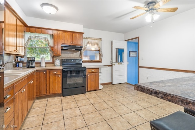 kitchen featuring sink, black electric range, light tile patterned flooring, and ceiling fan