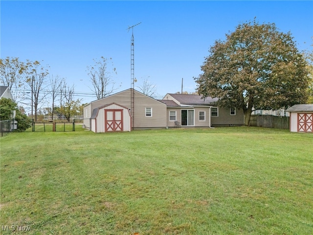 rear view of house with a storage unit and a yard