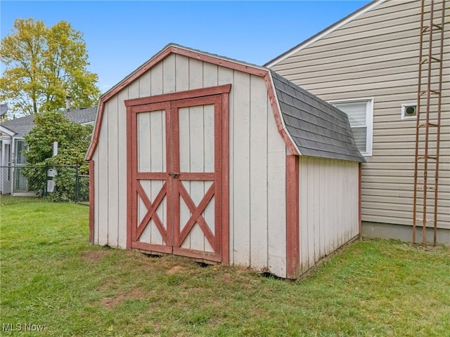 view of outdoor structure featuring a lawn