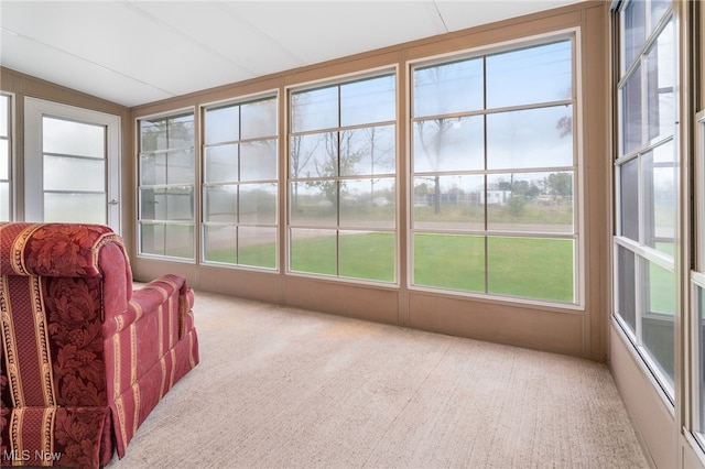 sunroom with vaulted ceiling and a healthy amount of sunlight