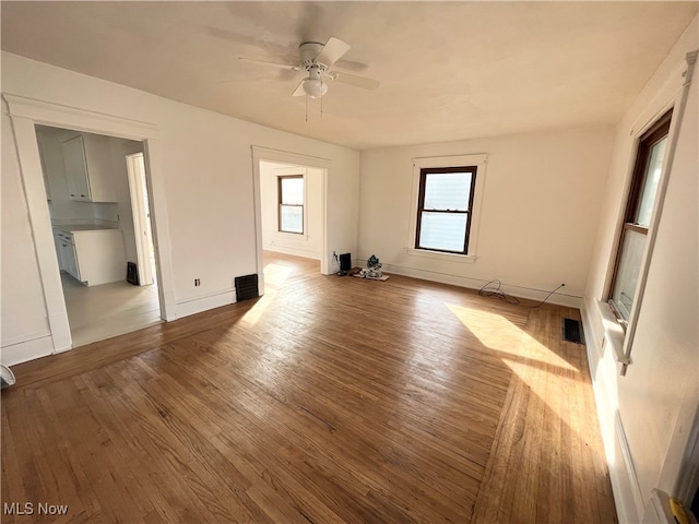 empty room featuring ceiling fan and light hardwood / wood-style flooring