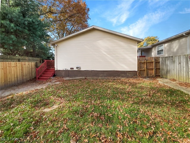 view of side of home featuring a yard