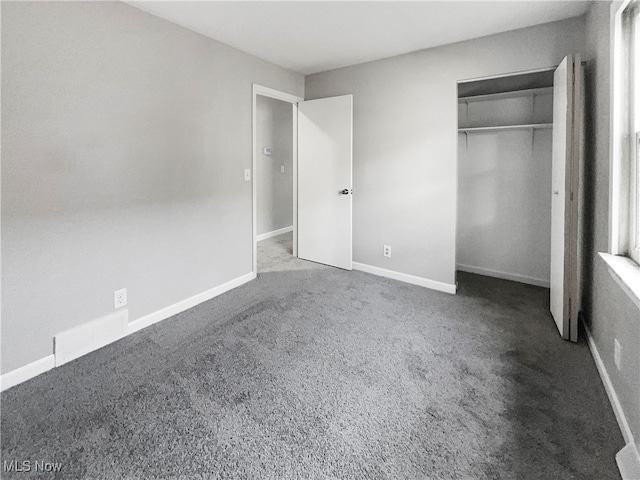 unfurnished bedroom featuring carpet floors and a closet