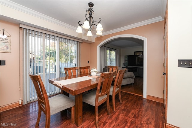 dining room featuring ornamental molding, a chandelier, and dark hardwood / wood-style flooring