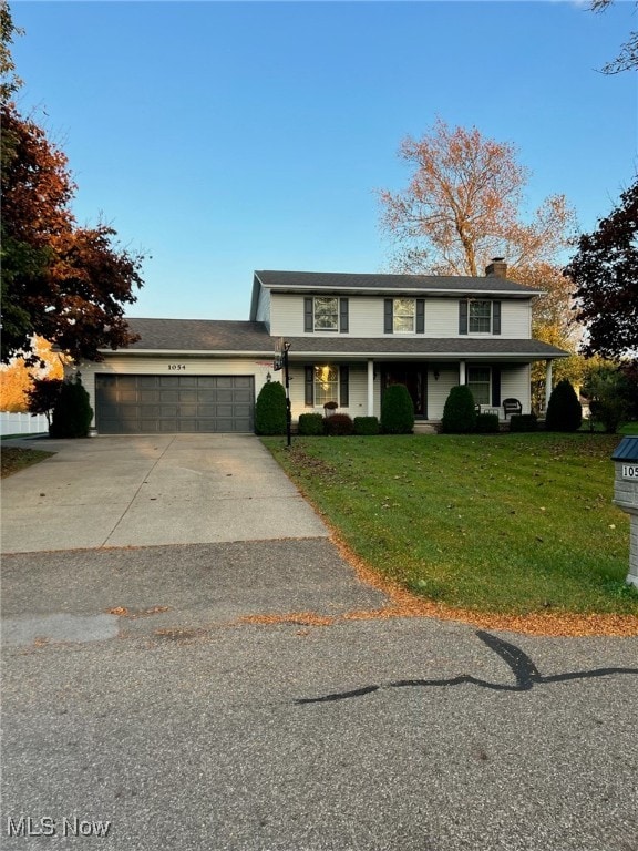 view of front of home with a garage and a front lawn