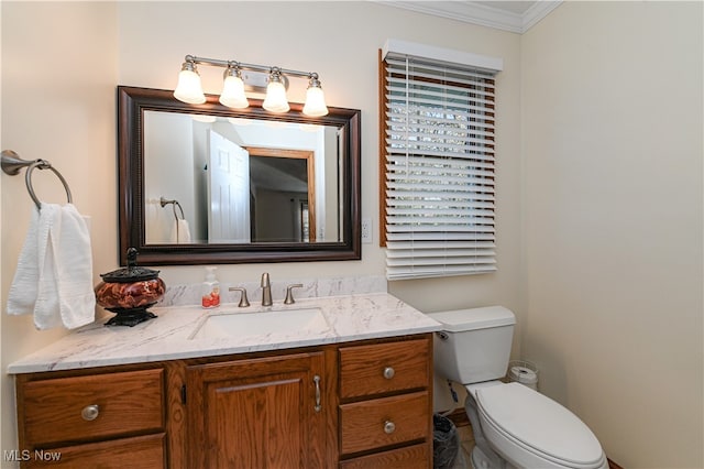 bathroom featuring vanity, crown molding, and toilet