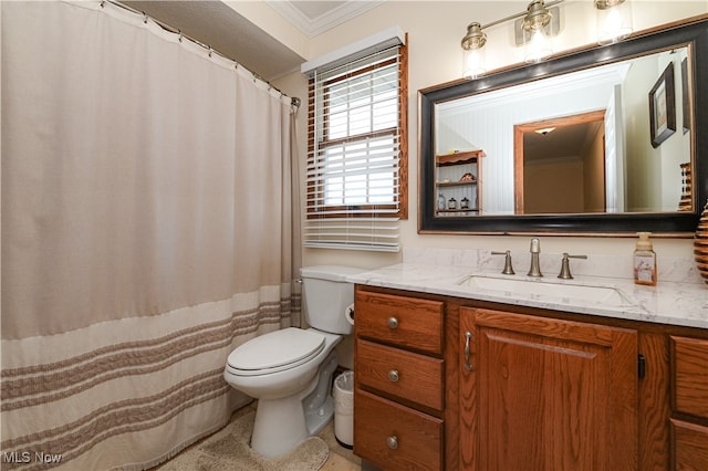 bathroom featuring vanity, ornamental molding, and toilet