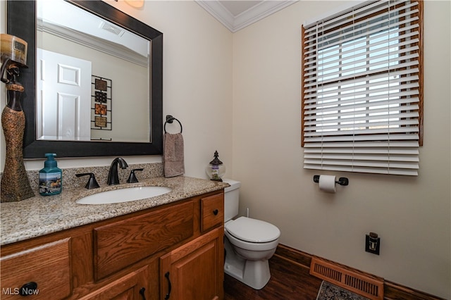 bathroom featuring vanity, toilet, crown molding, and hardwood / wood-style flooring