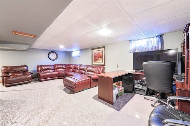 carpeted living room with a paneled ceiling