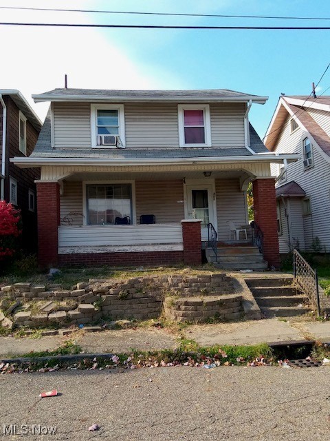 view of front facade featuring a porch and cooling unit