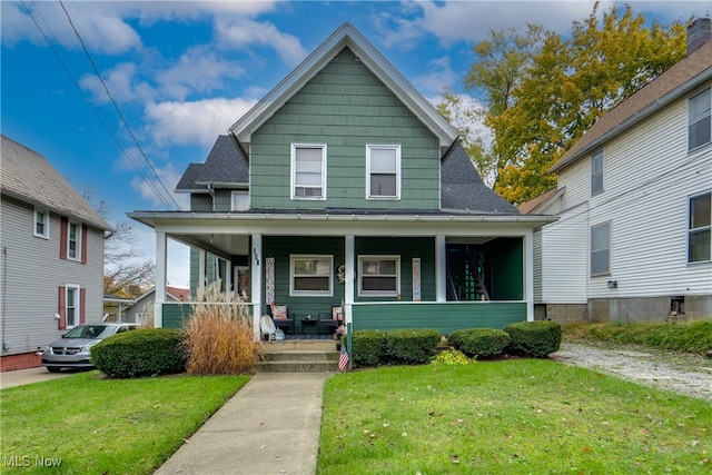 bungalow-style home with covered porch and a front yard