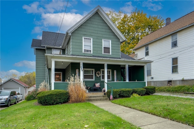 view of front of house featuring covered porch, a garage, and a front lawn