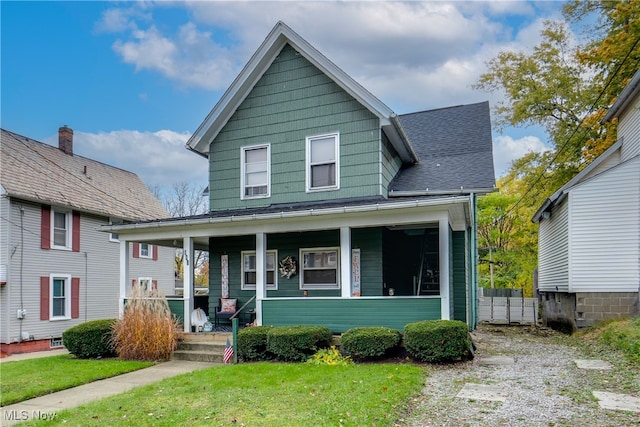 view of front of house featuring a front yard and covered porch