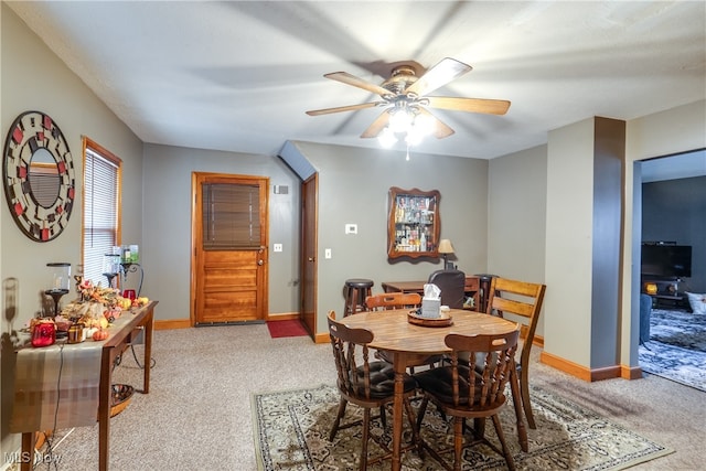 dining space featuring carpet and ceiling fan