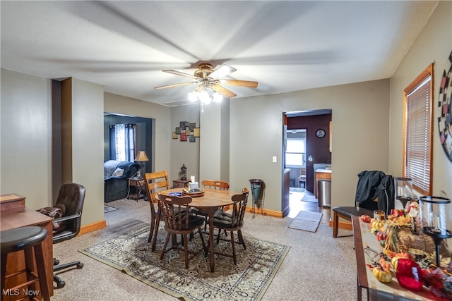 dining space featuring carpet flooring and ceiling fan