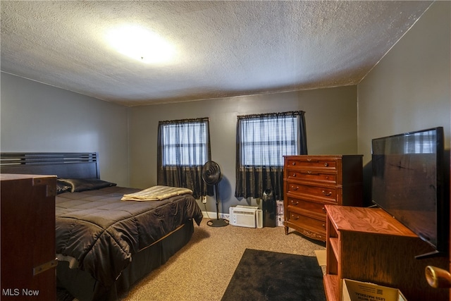 carpeted bedroom featuring a textured ceiling