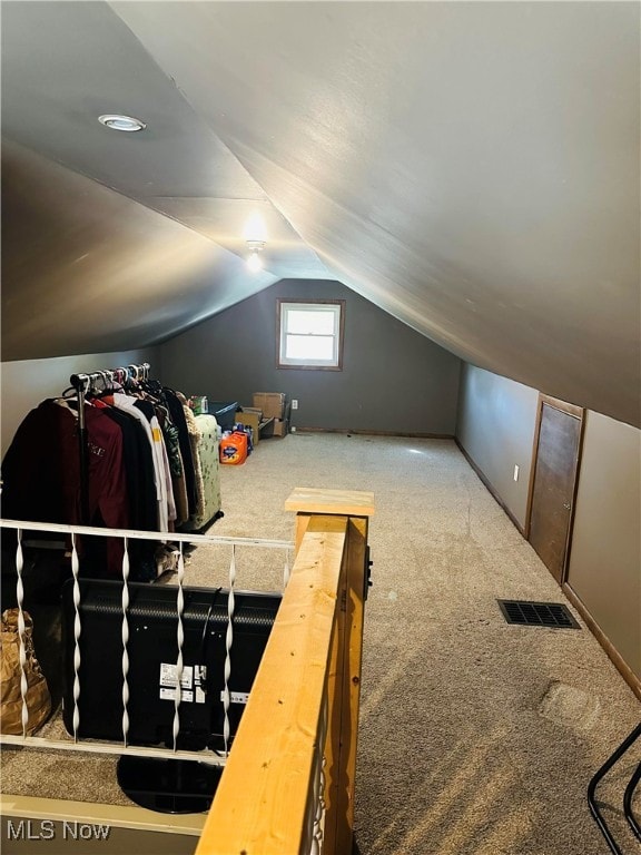 additional living space with carpet floors and vaulted ceiling