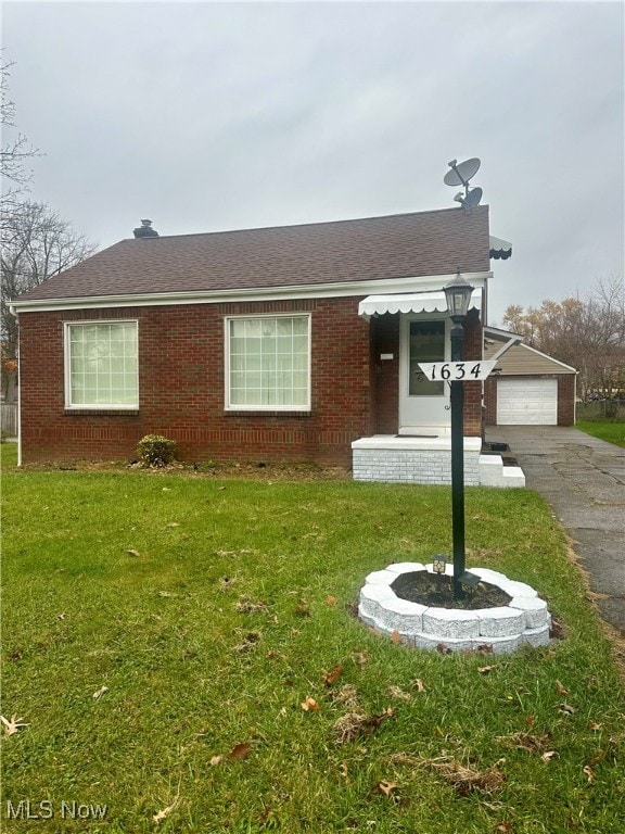 view of front of property with a front yard and a garage