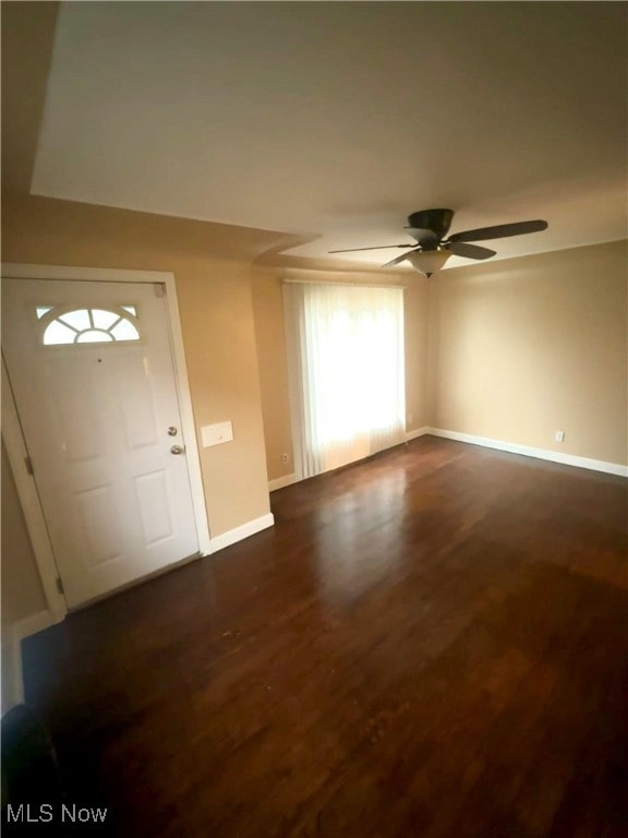 foyer entrance with ceiling fan and dark hardwood / wood-style flooring