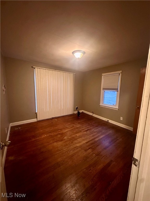 unfurnished room featuring dark hardwood / wood-style floors