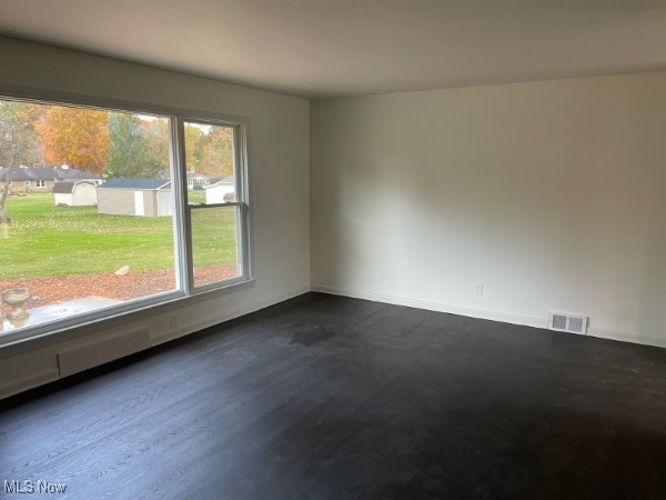 empty room with dark wood-type flooring