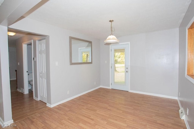 spare room with light hardwood / wood-style floors