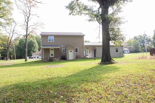 rear view of house featuring a yard