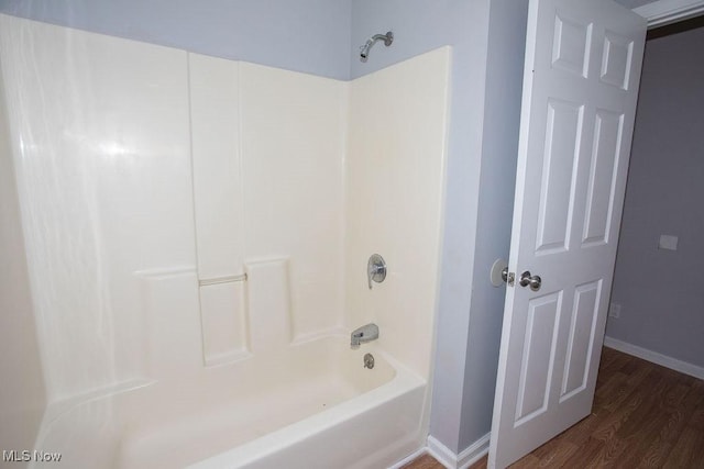 bathroom featuring hardwood / wood-style floors and shower / bath combination