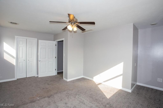 unfurnished bedroom with carpet, ceiling fan, and a closet