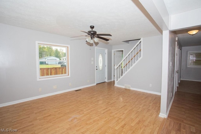 unfurnished living room with ceiling fan and light hardwood / wood-style flooring