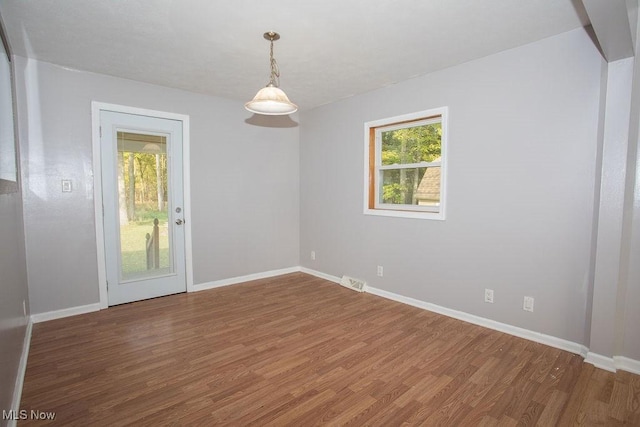 empty room with dark hardwood / wood-style flooring