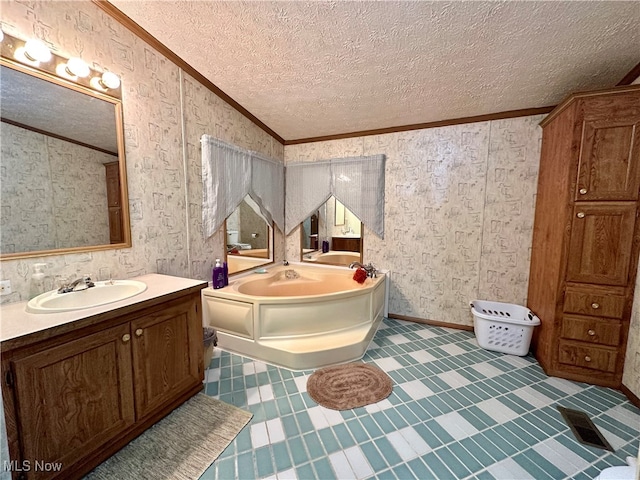 bathroom with vanity, crown molding, a bathtub, and a textured ceiling