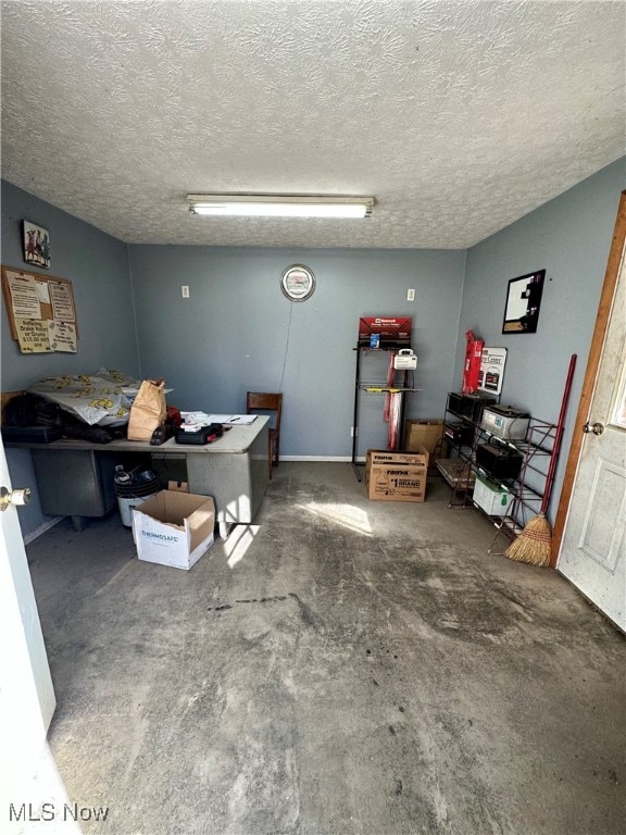 interior space with concrete flooring and a textured ceiling