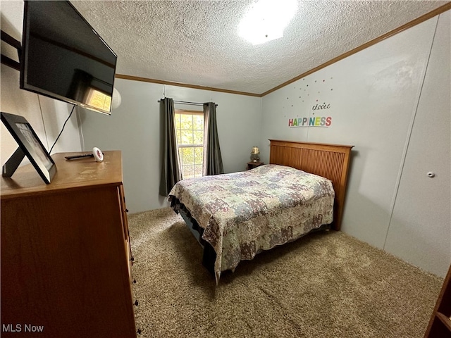 bedroom featuring ornamental molding, a textured ceiling, and carpet floors