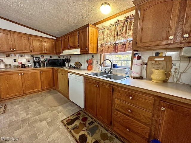 kitchen featuring lofted ceiling, a textured ceiling, sink, and white dishwasher