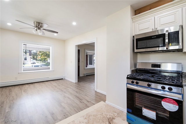 kitchen featuring light hardwood / wood-style floors, white cabinets, stainless steel appliances, and a baseboard radiator