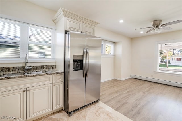 kitchen featuring light hardwood / wood-style flooring, sink, plenty of natural light, and stainless steel fridge with ice dispenser