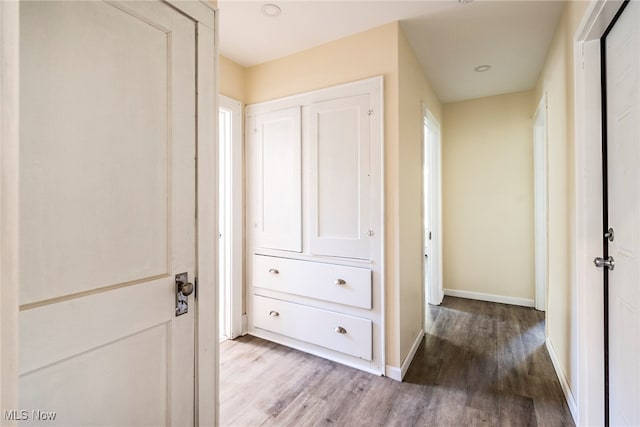 hallway with light hardwood / wood-style floors