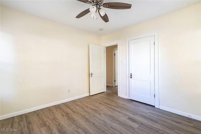 unfurnished bedroom with ceiling fan and hardwood / wood-style floors